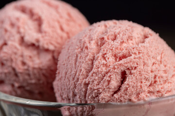 red strawberry-flavored ice cream in a glass bowl