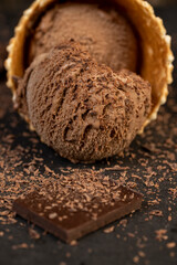 chocolate ice cream with chocolate chips on black slate