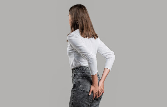 Person farting. Woman suffering from hemorrhoids, anal pain. Woman holds his hands to the ass feeling pain. Hemorrhoids. Anus. Pain. Woman hand holding her bottom, abdominal pain and hemorrhoids