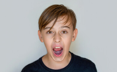 Scream. Child with angry expression. Shocked panic kid boy, screaming in despair, frustration.Young...