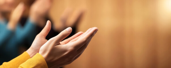 Fototapeta premium Closeup of clapping hands, blurred figures in the background, soft lighting, teamwork celebration, successful collaboration