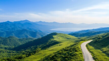 Fototapeta premium Scenic Mountain Roads - Picturesque Winding Routes Through Lush Hilltops with Panoramic Valley Views and Distant Peaks for Perfect Scenic Drives