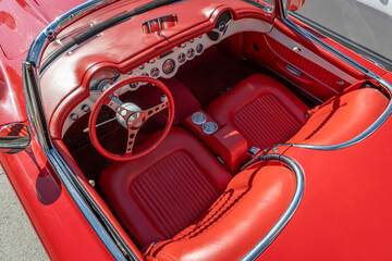Interior of a classic vintage car, red leather.