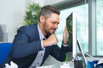 man almost punching the computer screen