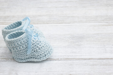 Blue baby booties crochet on wood