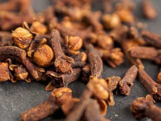 A close-up of aromatic cloves, highlighting the texture and rich color