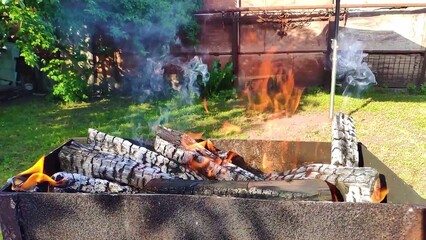 Barbecue fire burning, flames of fire and smoke for the grill