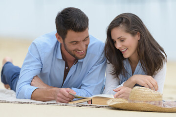 happy couple relaxing on the sandy beach