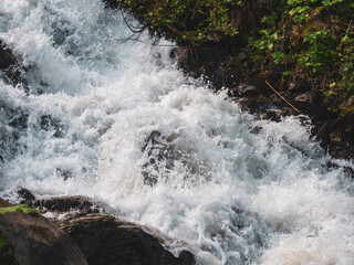 A mountain river with a rapid flow: a mesmerizing stream of water, framed by picturesque mountain...
