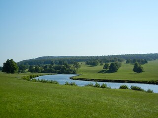 Obraz premium Lush Riverside Landscape with Trees