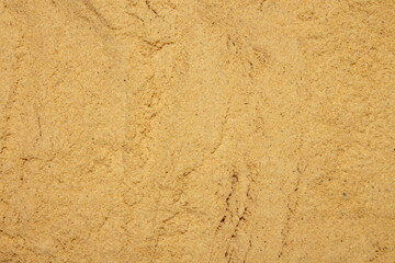 Mustard powder from mustard seeds.Mustard powder texture. The base is made of mustard powder.