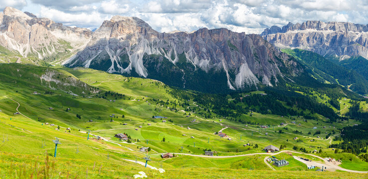 panoramic view of rocky mountain and blanket-like grass covered valley in summer, Seceda, Dolomites, Italy