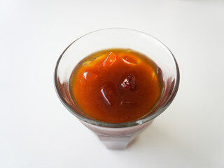 Glass of ice black coffee isolated on white background from top view