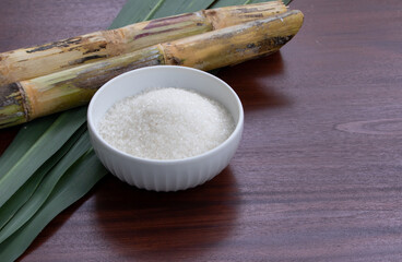 White Sugar in Ceramic Bowl with Cane on Wooden Table – Natural Sweetener Display