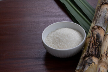 White Sugar in Ceramic Bowl with Cane on Wooden Table – Natural Sweetener Display