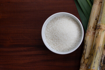 Kitchen Essentials – White Sugar in Bowl with cane and Cane Leaves