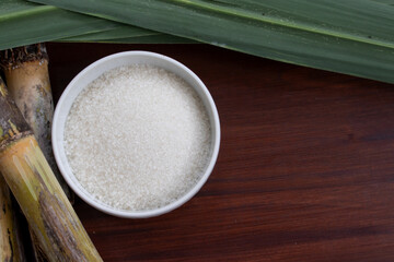 Granulated White Sugar in Ceramic Bowl with Cane Leaves Accent