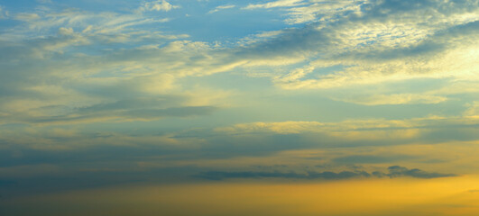 Fototapeta premium sunset Sky background, Sunrise sky with lighted clouds. Wide photo.