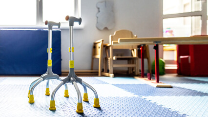 Rehabilitation tools for children are set up in a colorful, well-lit therapy room designed for physical development and healing © Peakstock