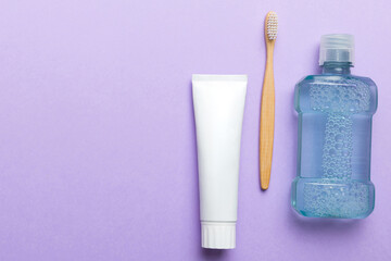Mouthwash and other oral hygiene products on colored table top view with copy space. Flat lay. Dental hygiene. Oral care products and space for text on light background. concept