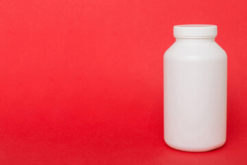 supplement pills with medicine bottle health care and medical top view. Vitamin tablets. Top view mockup bottle for pills and vitamins with green leaves, natural organic bio supplement, copy space