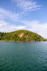 Tropical tranquility Island with sea and clouds sky.