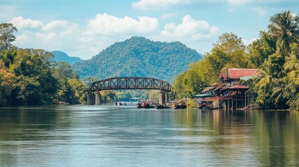 Naklejka premium The historic bridge over the River Kwai, a significant World War II landmark in Kanchanaburi.