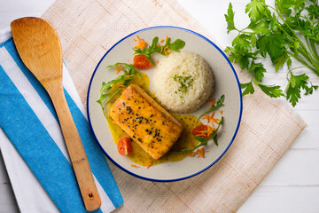 Baked salmon with orange sauce. Top view table with  decoration.