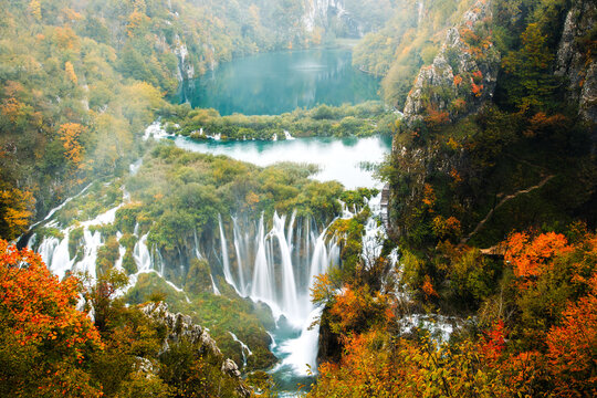 Scenic Autumn Waterfall in Serene Forest Setting