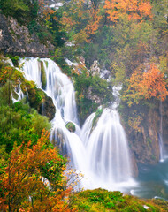 Scenic Autumn Waterfall in Serene Forest Setting