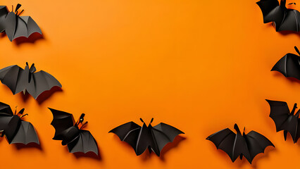 Paper bats for Halloween party on orange background