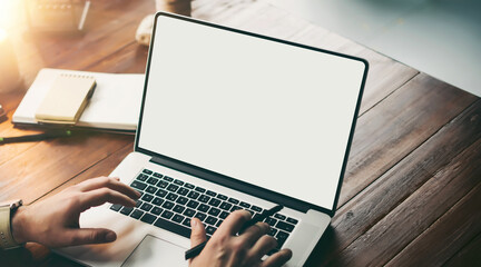 Close up of male hands and laptop with blank screen. Mock-up of computer monitor. Copyspace ready for design or text