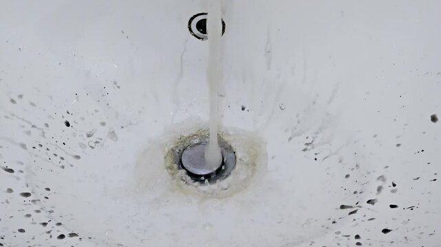 black water flowing through a basin tap faucet after fixing a water pipe then water starts to clear as it flows in a bathroom or kitchen, save water, leakage, outage, fixation of pipelines