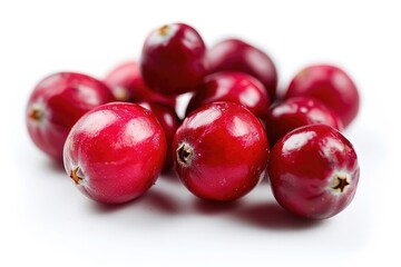 A fresh pile of cranberries on a white surface