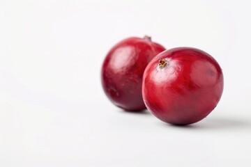 Obraz premium A pair of juicy red apples sit side by side on a clean white surface