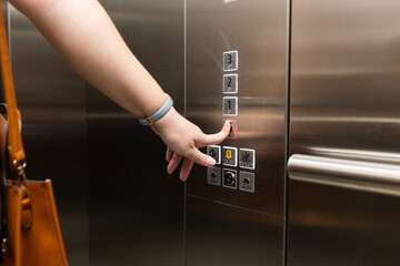 Pressing elevator button, person with handbag using elevator in office building © WavebreakMediaMicro