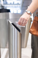 Obraz premium Scanning access card, woman entering office building through security turnstile