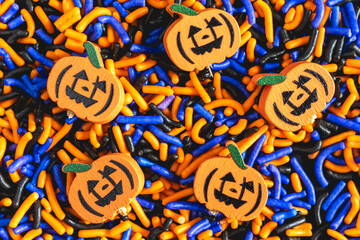 Colorful sweet decoration in halloween colors with pumpkin figures. Halloween Background.