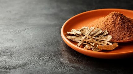 Dried chicory root and powder on an orange plate, symbolizing natural health and digestive benefits