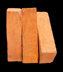 Side view of old red or orange bricks in stack isolated on black background with clipping path