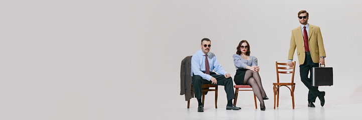 Obraz premium Banner. Business experts seated with air of authority, showcasing classic business style with modern against white background with copy space. Concept of corporate culture, leadership. Ad