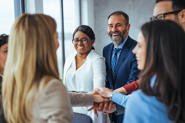 Diverse Business Team Celebrating Success with Group Handshake
