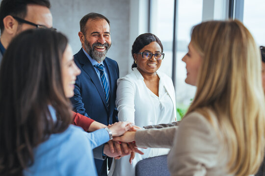 Diverse Business Team Celebrating Success with Handshake Unity