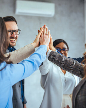 Diverse Team Achieving Success with Unified High Five Gesture
