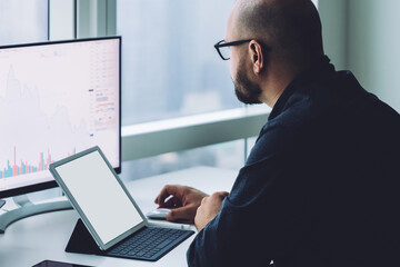 Adult employee with gadgets at desk