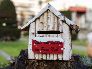 Wooden white mailbox for Santa’s letters. French inscription that means 
