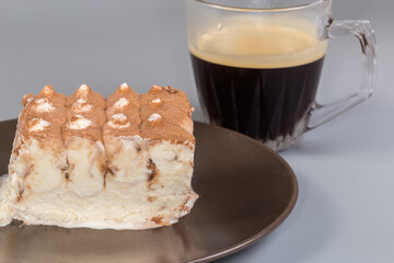 Ice cream sprinkled with cocoa powder against cup of coffee