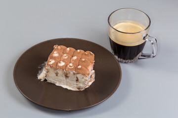 Ice cream sprinkled with cocoa powder against cup of coffee