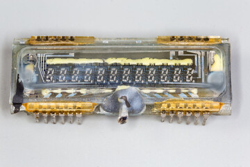 Old digital vacuum fluorescent display on a gray background
