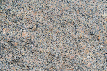 The texture of the granular granite in the photo shows a light stone with a fine granular structure. The stone has a uniform grain distribution, creating a smooth but textured appearance, with shades